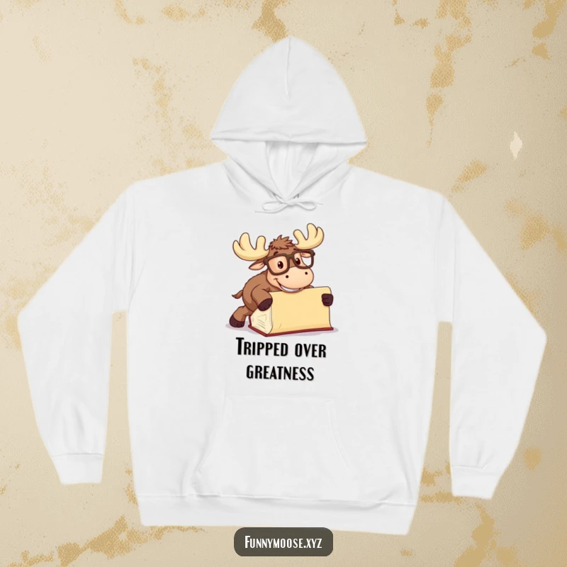 Funny Moose Hoodie, a moose in oversized glasses tripping over a book, comfortable and humorous apparel.