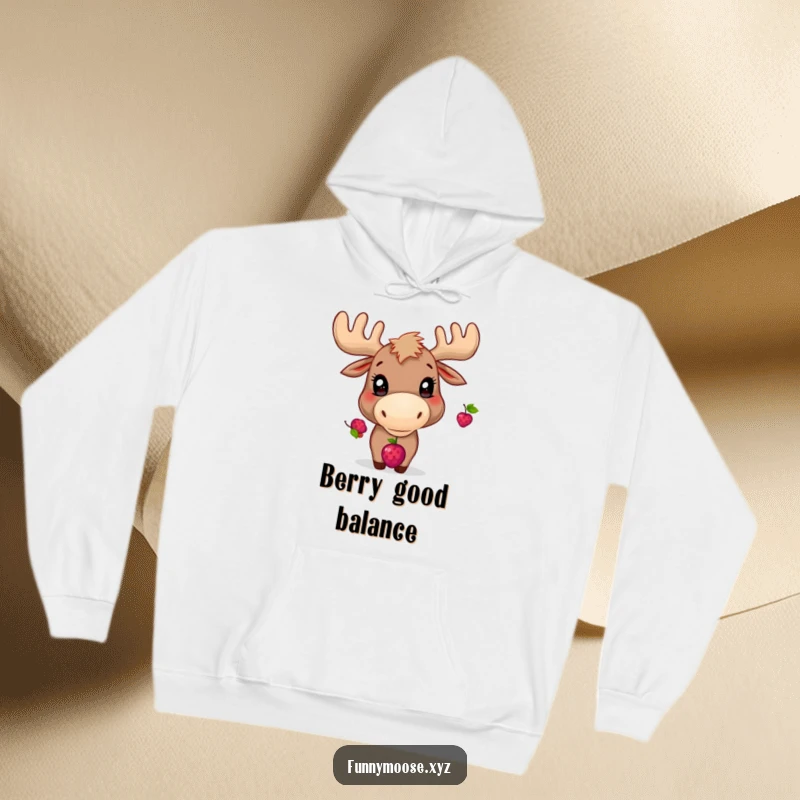 Funny hoodie art of a playful moose with bright eyes, diligently balancing a berry on its nose.