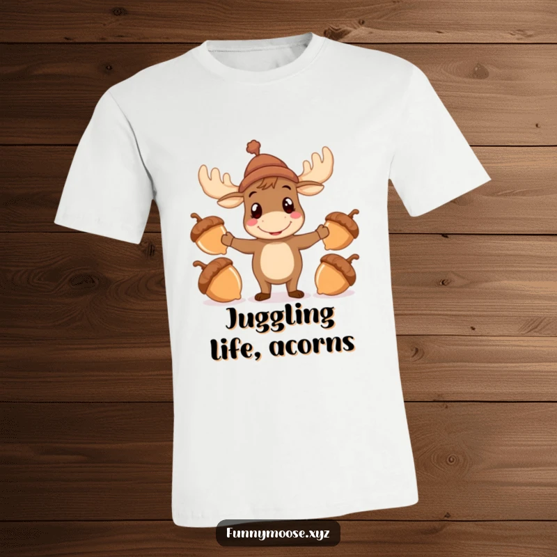 Funny Moose T-Shirt with a hat attempting to juggle acorns, a humorous and whimsical graphic tee.